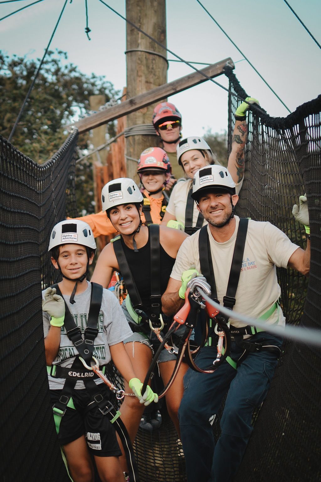Group in harnesses and helmets on a platform of the Adventure Park treetop course in Buellton
