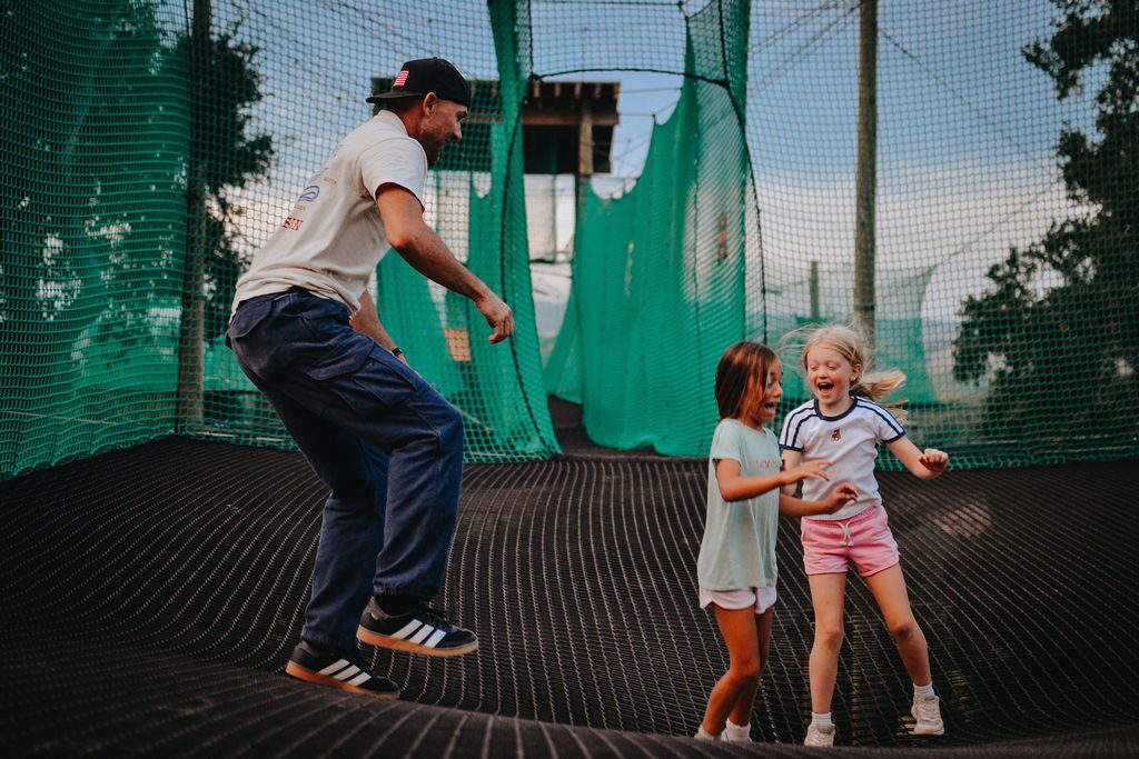 Family bouncing together on the enclosed nets of the Skynet Playground at Highline Adventures, Buellton