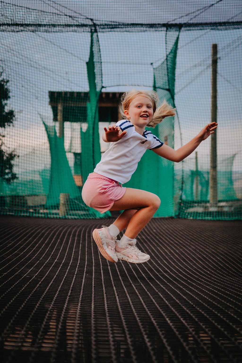 Girl jumping on the Skynet Playground netting at Highline Adventures
