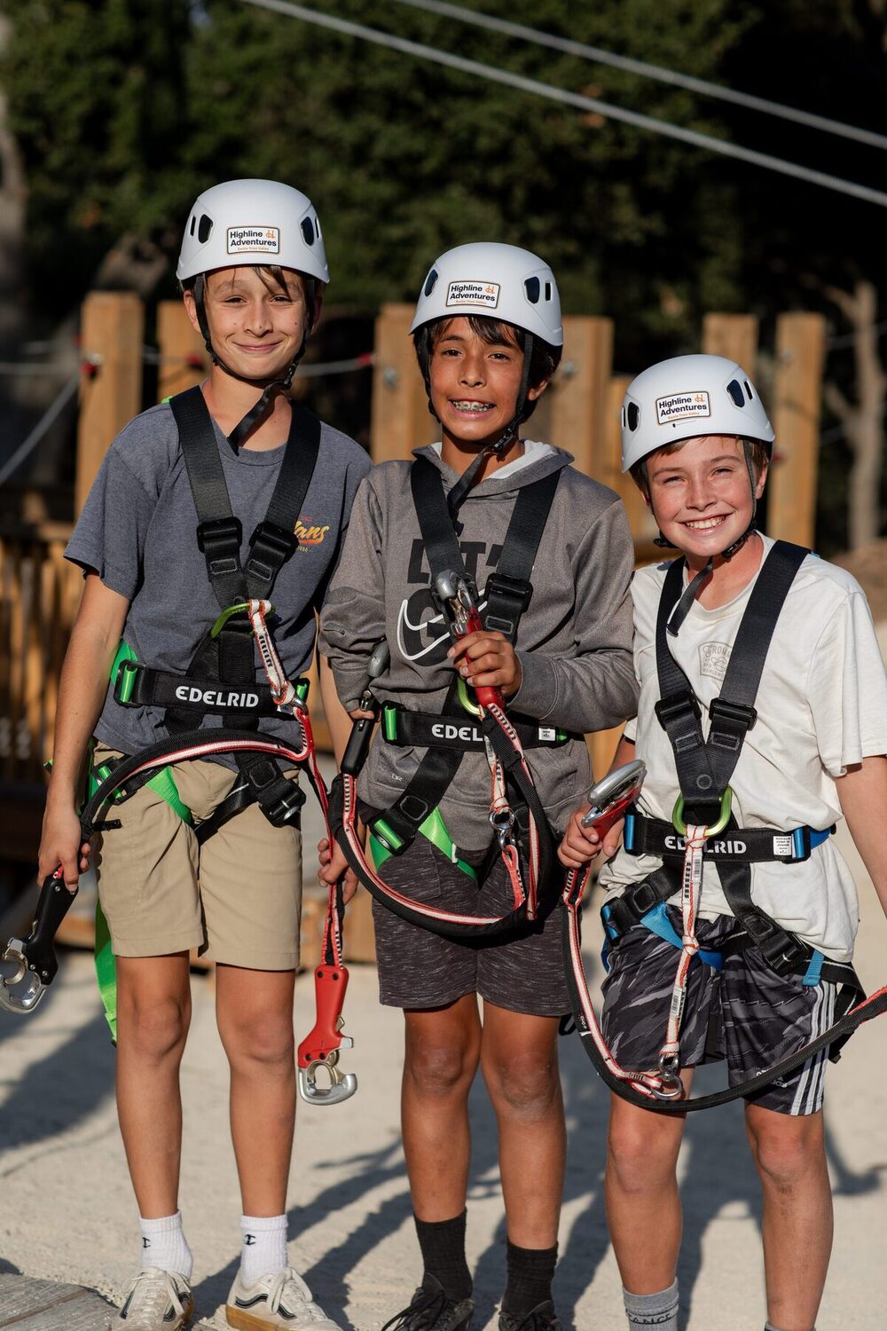 Adults working through a high element on the 65-element treetop ropes course at Highline Adventures Adventure Park.