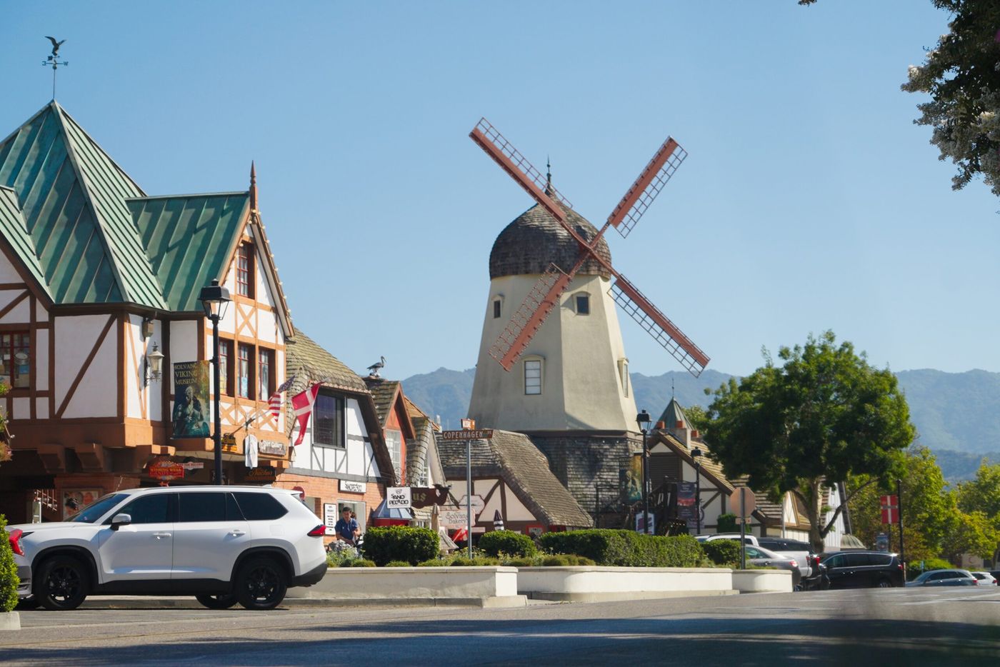 Solvang's Danish-style windmill and half-timbered buildings under a blue sky.