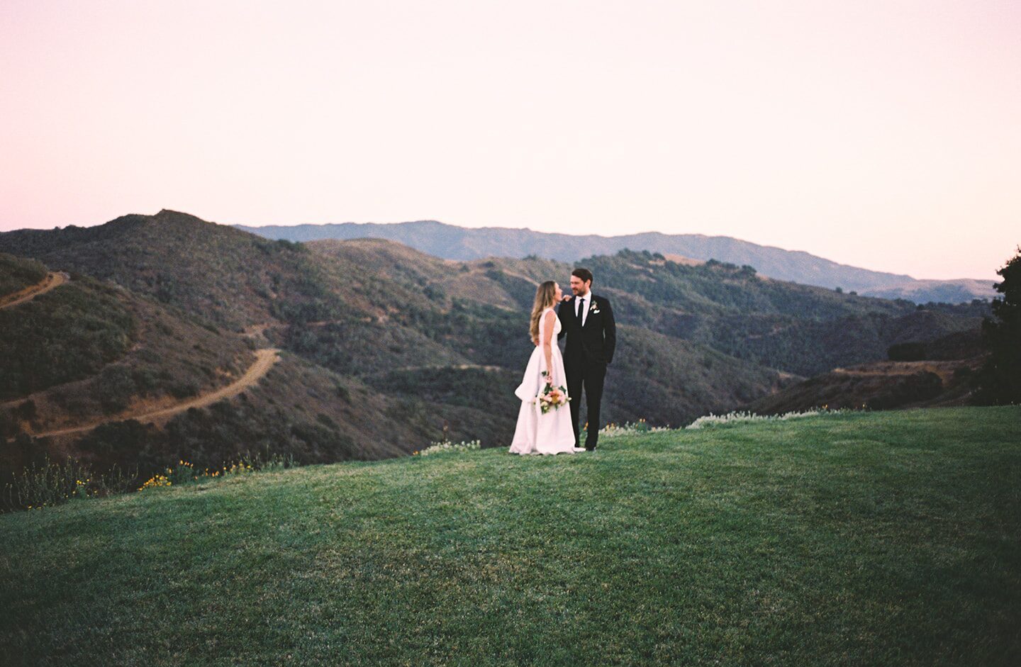 Tiffany and Andrew on the ridge above the Santa Ynez Valley at sunset.
