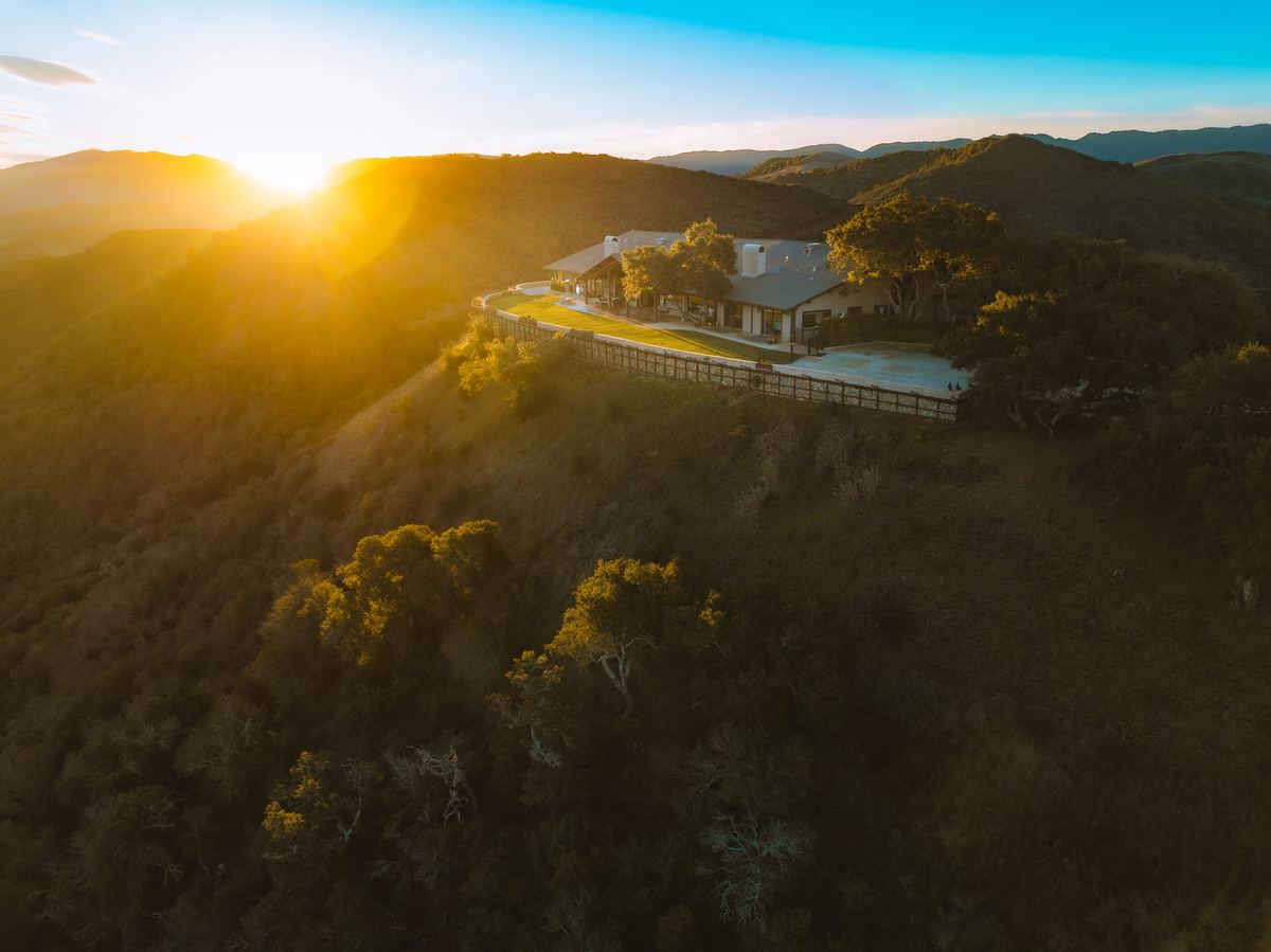Drone view of the Summit House on its hilltop at sunset.