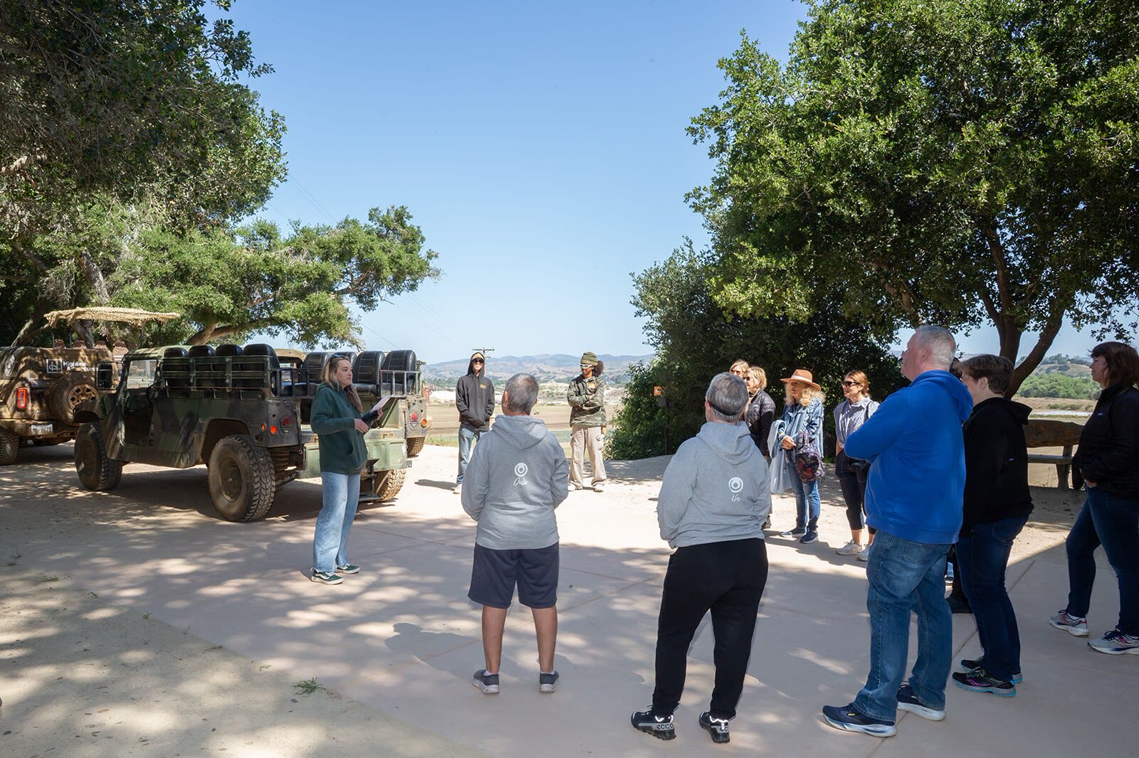 A group gathered at basecamp beside the Broncos before their tour at Highline Adventures.