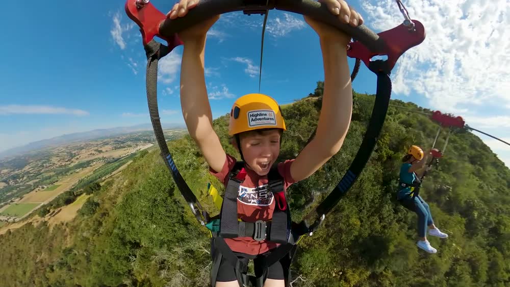 Two riders side by side on the zipline above the Santa Ynez Valley.